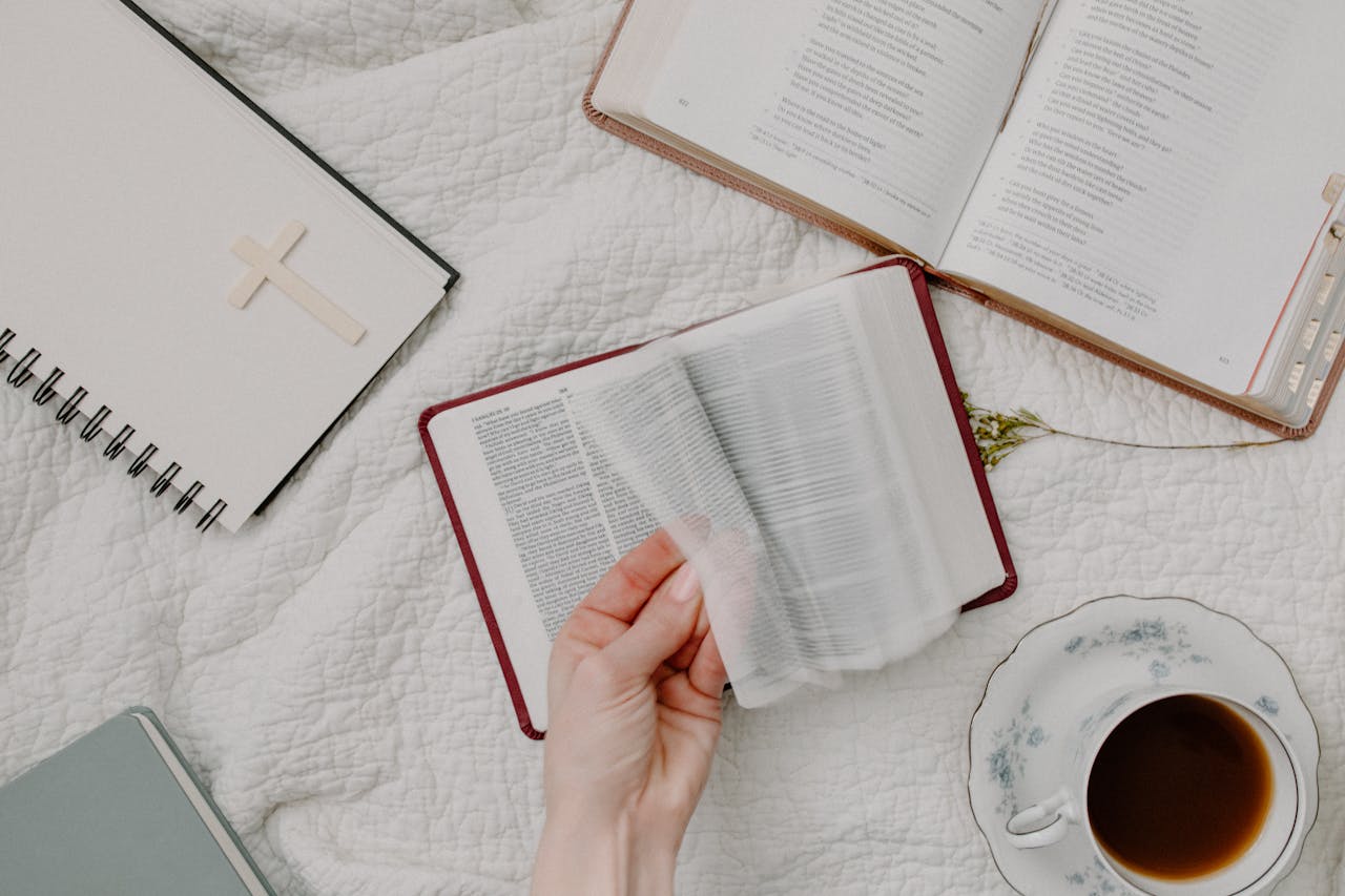 The Art of Drawing Readers In: Your attractive post title goes here A cozy setup of Bible reading with a cup of coffee, evoking a peaceful morning routine.
