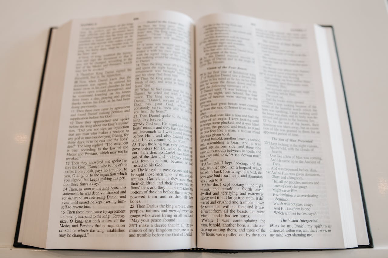 Mastering the First Impression: Your intriguing post title goes here An open Holy Bible on a wooden table, showcasing scripture text, ideal for religious and spiritual themes.